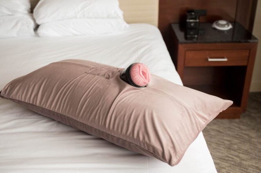 Liberator Humphrey pillow holding a full-size fleshlight masturbator lying on a bed