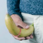 Man holding banana to demonstrate curvature of penis