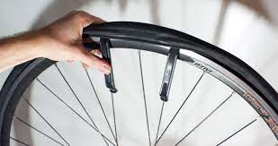 hand holding bicycle wheel with inner tube out