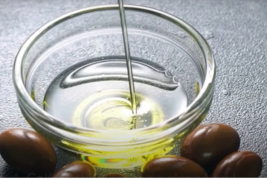 Almond oil pouring into bowl