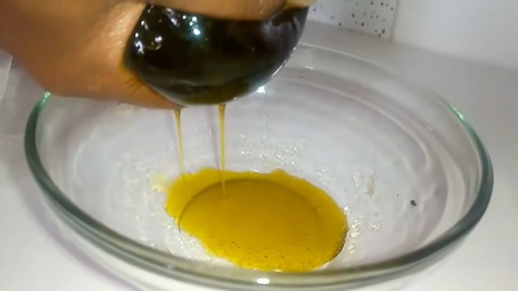 Avocado oil being squeezed from a cheese cloth