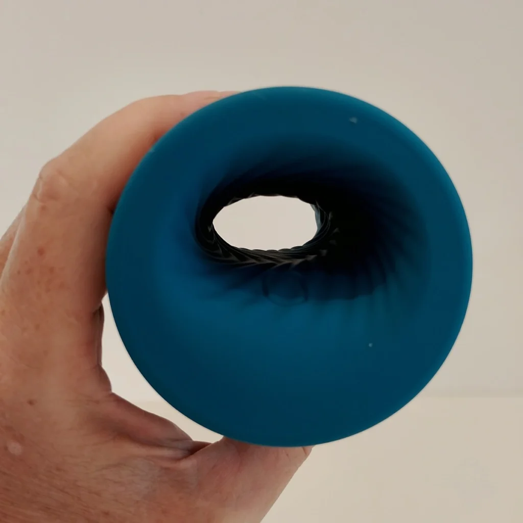 LELO f2s double Sonic in hand side shot through the open ended hole charging port end